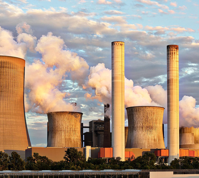 An exterior shot of a power plant at dusk.