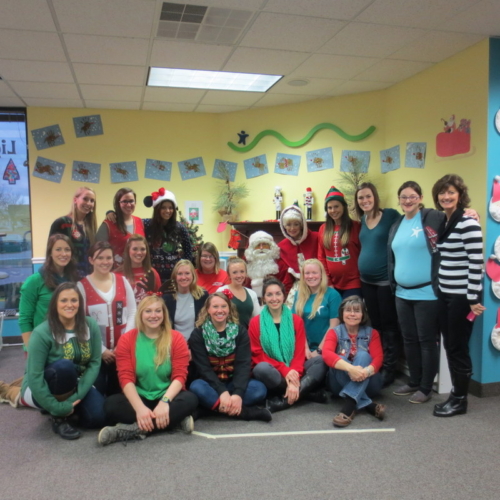 Staff gather for a photo with Mr. and Mrs. Clause