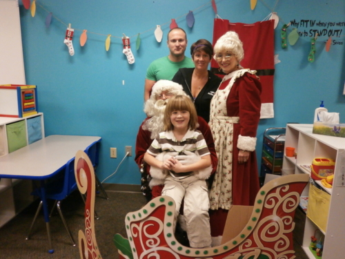 One of our kiddos in Warsaw with his parents and Mr. and Mrs. Clause