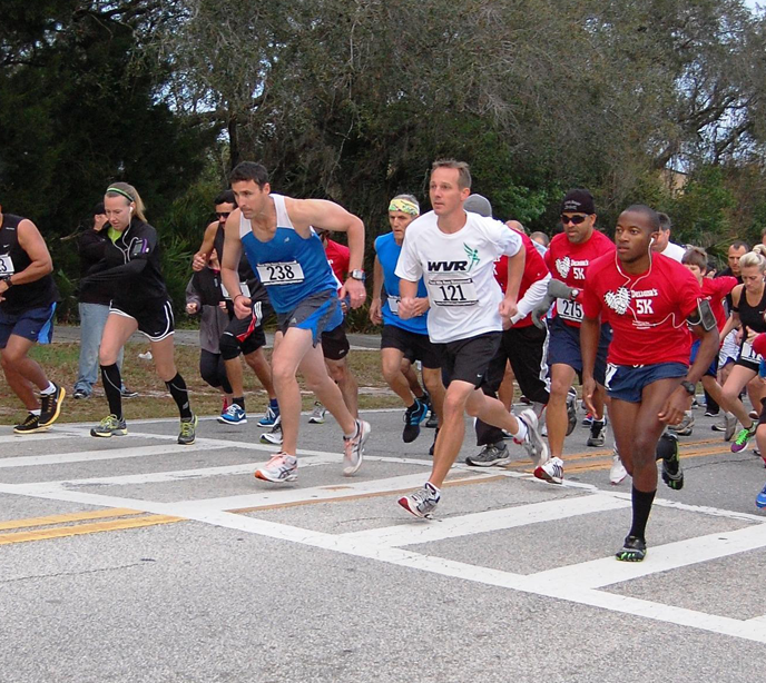 A group of runners running in an autism benefit race.