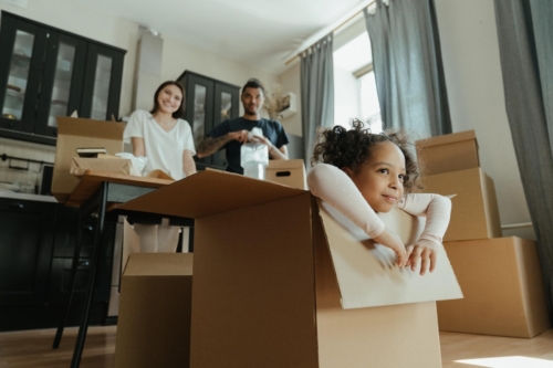 child and parents moving to new house