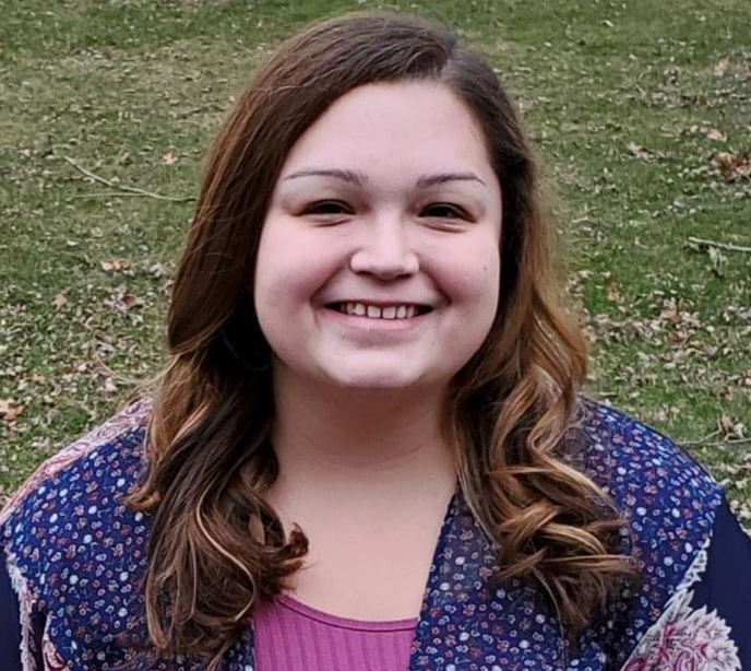 A portrait of Ashley Ritchey smiling wearing a blue top