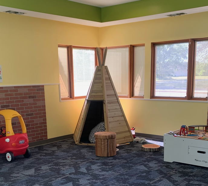 A room inside the Lighthouse Autism Center in Portage Indiana with a wooden teepee and set of draws with toys