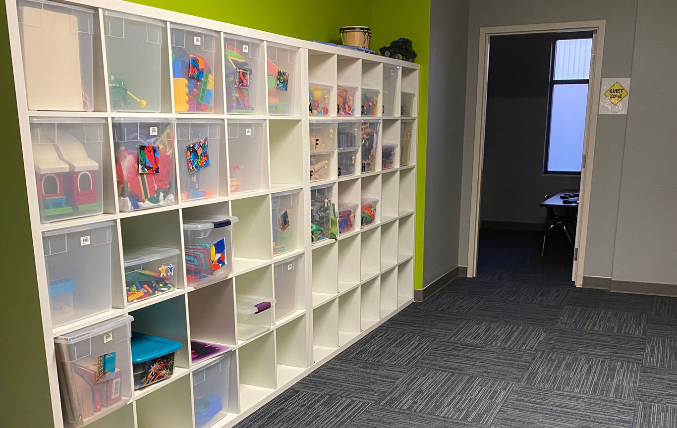 A room with a shelving unit inside the Lighthouse Autism Center Greenfield location