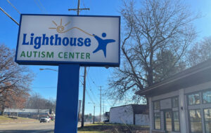 An exterior shot of a sign and building of Lighthouse Autism Center in Kalamazoo