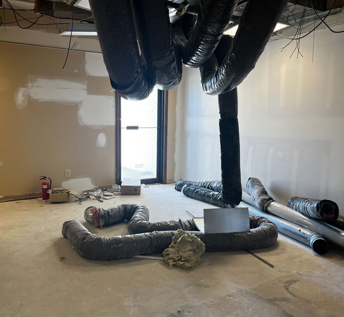 A room at the Castleton Lighthouse Autism Center with plastic pipes hanging from the ceiling and other pieces on the floor