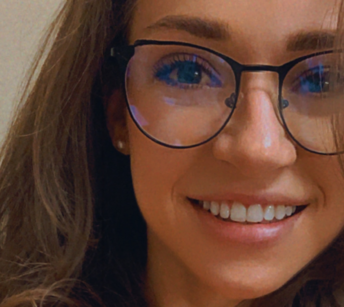 Close up shot of a Lighthouse Autism Center member of staff wearing glasses and smiling