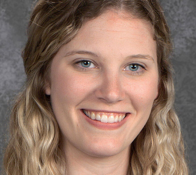 A portrait photo of a woman smiling